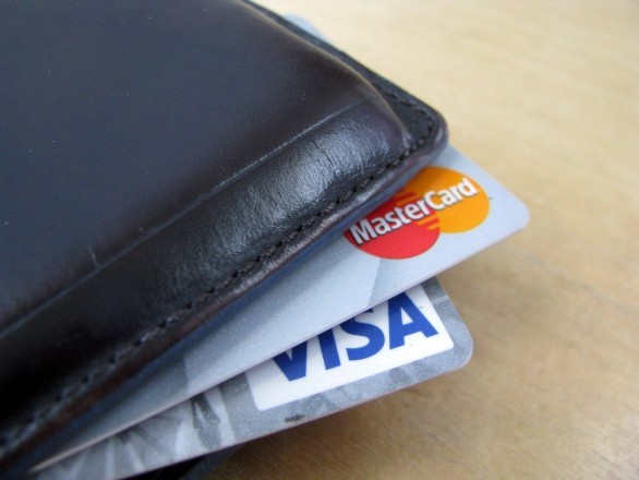 Visa and MasterCard poking out of a wallet