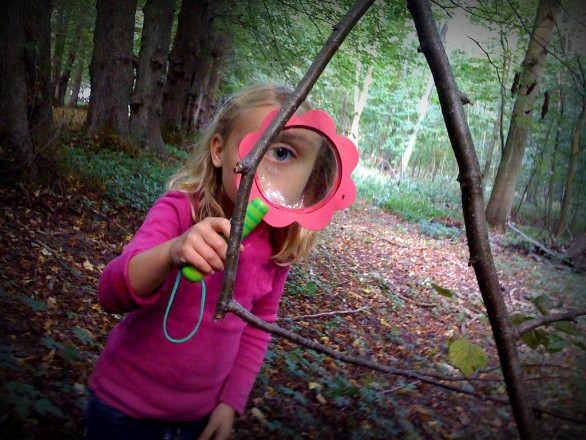 Kid with magnifying glass